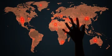 Global map highlighting nuclear proliferation risks with a hand preventing a mushroom cloud.