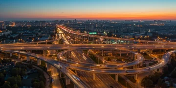 2025 Federal Infrastructure Bill: Opportunities & Challenges Modern highway interchange at dusk symbolizing infrastructure investment