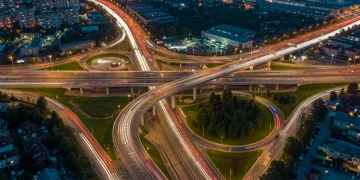 U.S. Infrastructure Spending: $1.2 Trillion Allocations & Economic Benefits Modern highway interchange at dusk, symbolizing US infrastructure investment